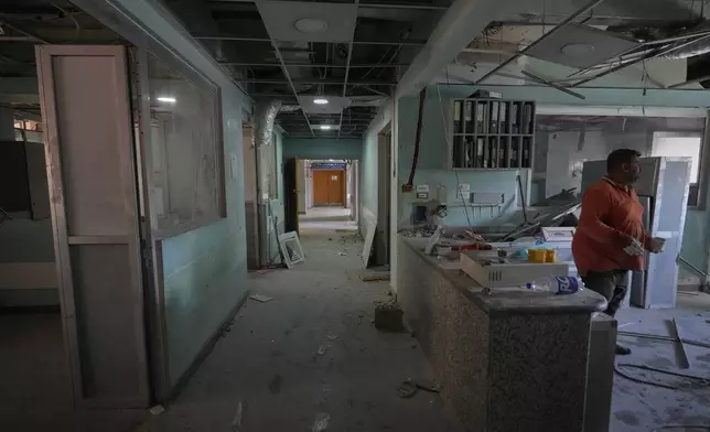 A worker repairs damage inside the Cardiac Care Unit at Jabal Amel Hospital, which was heavily damaged in Israeli strikes that hit nearby buildings earlier this month, in the southern port city of Tyre, Lebanon, Thursday, June 18, 2026. (AP Photo/Hassan Ammar)
