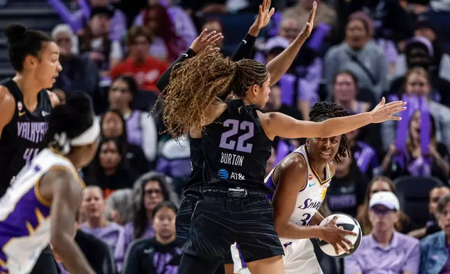 Los Angeles Sparks' Nneka Ogumwike, right, looks for help from a teammate as she is defended by Golden State Valkyries' Veronica Burton (22) in the first half of a WNBA basketball game Monday, June 15, 2026, in San Francisco. (Carlos Avila Gonzalez/San Francisco Chronicle via AP)