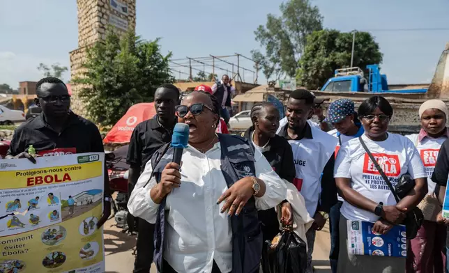 Jolie Milete, a staff member of the World Health Organization (WHO), addresses a crowd during an awareness campaign to combat Ebola in Bunia, Congo, Wednesday, June 10, 2026. (AP Photo/Moses Sawasawa)