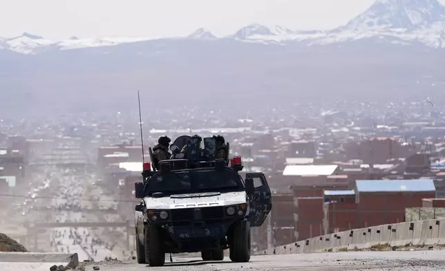 Police patrol a highway after President Rodrigo Paz declared a state of emergency to empower the military to remove road blockades, in El Alto, Bolivia, Saturday, June 20, 2026. (AP Photo/Juan Karita)