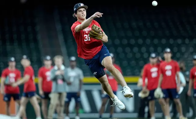 Archer Horn, a shortstop from St. Ignatius High School, throws to first base at the MLB baseball combine in Phoenix, Tuesday, June 23, 2026. (AP Photo/Ross D. Franklin)