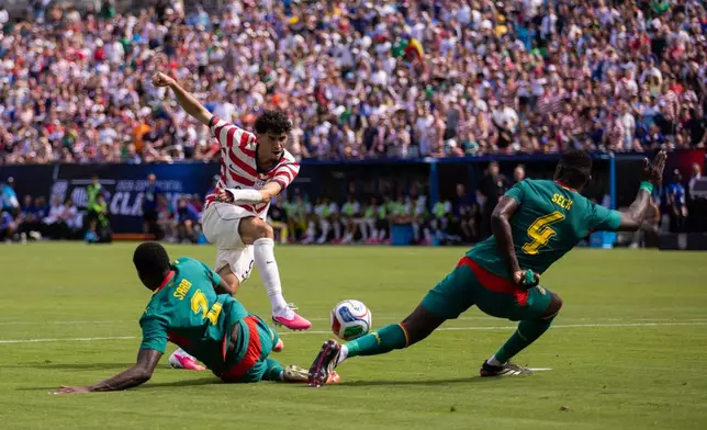 United States forward Ricardo Pepi, top left, has a shot blocked by Senegal defender Abdoulaye Seck (4) during the first half of an international friendly soccer match Sunday, May 31, 2026, in Charlotte, N.C. (AP Photo/Scott Kinser)