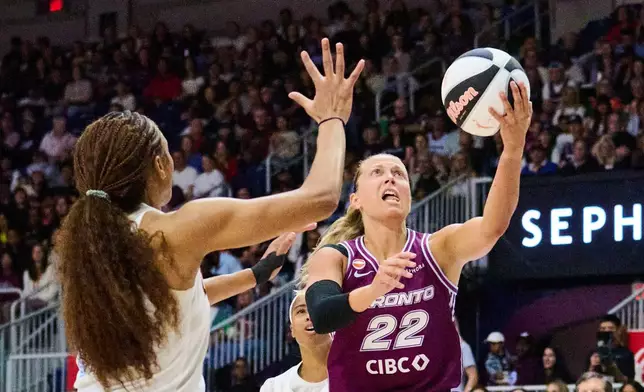Toronto Tempo's Julie Allemand (22) drives to the net past Atlanta Dream's Naz Hillmon, left, during the first half of a WNBA basketball game in Toronto, Sunday, June 14, 2026. (Sammy Kogan/The Canadian Press via AP)