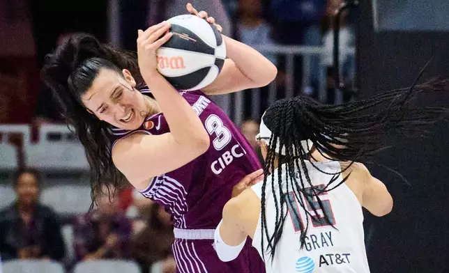 Toronto Tempo's Marina Mabrey (3) and Atlanta Dream's Allisha Gray (15) battle for the ball during the first half of a WNBA basketball game in Toronto, Sunday, June 14, 2026. (Sammy Kogan/The Canadian Press via AP)