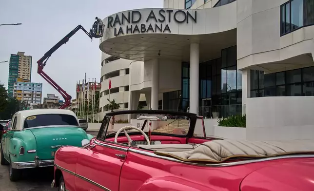 Workers repair the sign at the Grand Aston Hotel in Havana, Wednesday, June 3, 2026. (AP Photo/Ramon Espinosa)