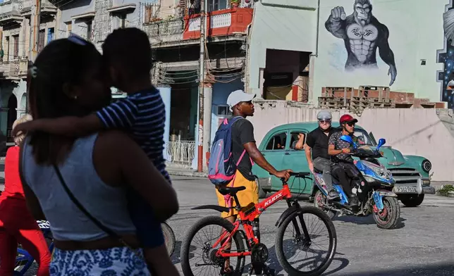 People traverse a street in Havana, Monday, May 25, 2026. (AP Photo/Jorge Luis Banos)