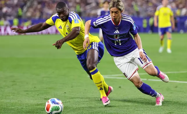 Japan's Junya Ito (14) and Sweden's Ken Sema (13) battle for the ball during the World Cup Group F soccer match between Japan and Sweden in Arlington, Texas, near Dallas, Thursday, June 25, 2026. (AP Photo/Sam Hodde)