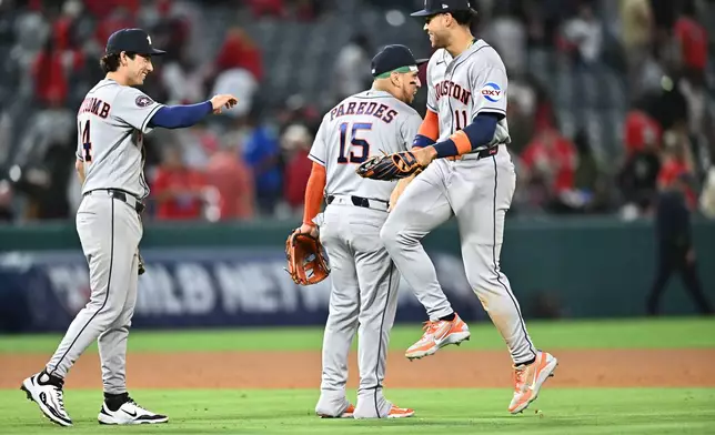 Houston Astros right fielder Cam Smith, right, is greeted by third baseman Isaac Paredes (15) after defeating the Los Angeles Angels in a baseball game Monday, June 8, 2026, in Anaheim, Calif. (AP Photo/William Liang)