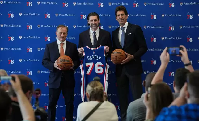 Mike Gansey, the Philadelphia 76ers' new president of basketball operations, center, poses for photographs with 76ers managing partner Josh Harris, left, and and Bob Myers, president of sports for Harris Blitzer Sports &amp; Entertainment, during a news conference at the NBA basketball team's training facility, Monday, June 8, 2026, in Camden, N.J. (AP Photo/Matt Rourke)