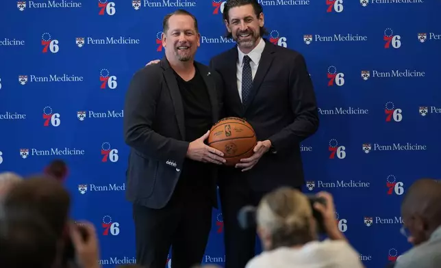 Mike Gansey, right, the Philadelphia 76ers' new president of basketball operations, and 76ers head coach Nick Nurse pose for photographs during a news conference at the NBA basketball team's training facility, Monday, June 8, 2026, in Camden, N.J. (AP Photo/Matt Rourke)