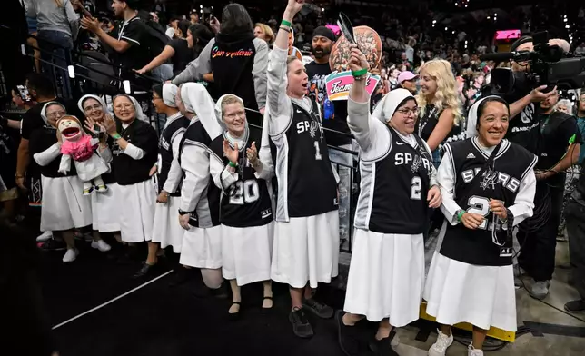 Nuns cheer before the first half of Game 6 in the Western Conference finals NBA basketball playoffs series between the San Antonio Spurs and the Oklahoma City Thunder, Thursday, May 28, 2026, in San Antonio. (AP Photo/Darren Abate)