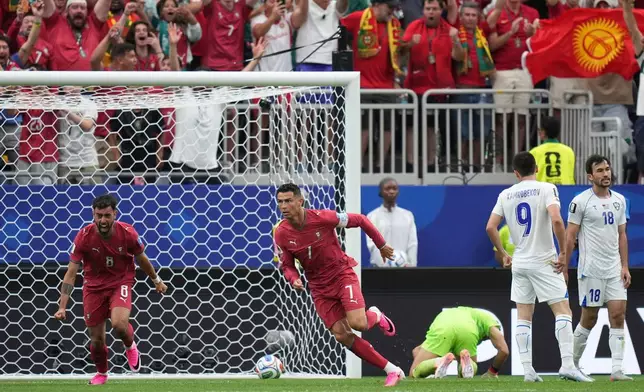 Portugal's Cristiano Ronaldo (7) celebrates after scoring the opening goal of his team during the World Cup Group K soccer match between Portugal and Uzbekistan in Houston, Tuesday, June 23, 2026. (AP Photo/Eric Gay)