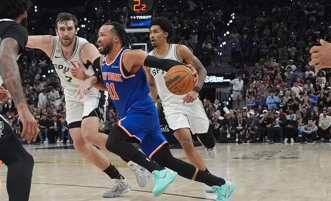 New York Knicks guard Jalen Brunson (11) drives as San Antonio Spurs center Luke Kornet (7) defends during the second half of Game 5 of the NBA Finals basketball series, Saturday, June 13, 2026, in San Antonio. (AP Photo/Ross D. Franklin)