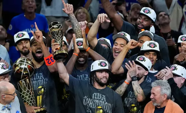 New York Knicks guard Jalen Brunson holds the MVP trophy after the Knicks defeated the San Antonio Spurs in Game 5 of the NBA Finals basketball series, Saturday, June 13, 2026, in San Antonio. (AP Photo/Ross D. Franklin)
