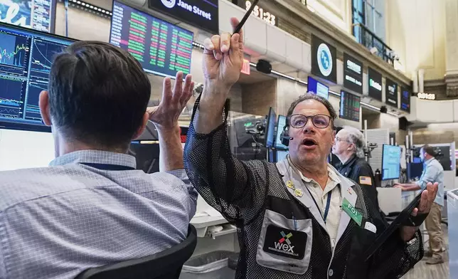 Options trader Anthony Spina, center, works on the floor of the New York Stock Exchange, Tuesday, June 16, 2026. (AP Photo/Richard Drew)