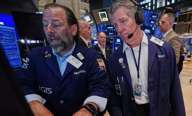Specialist Michael Pistillo, left, and trader Sean Spain work on the floor of the New York Stock Exchange, Tuesday, June 16, 2026. (AP Photo/Richard Drew)