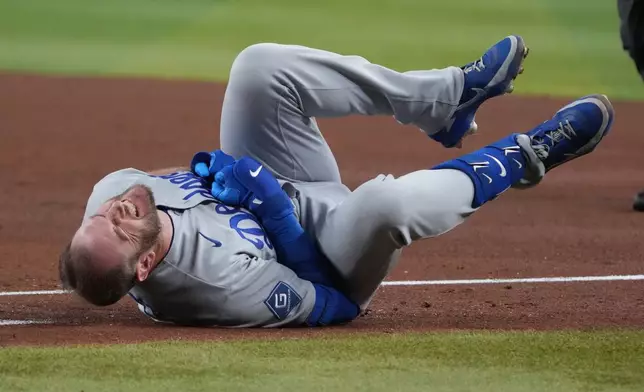 Los Angeles Dodgers' Max Muncy reacts after colliding with Arizona Diamondbacks first baseman Ildemaro Vargas in the fifth inning of a baseball game, Thursday, June 4, 2026, in Phoenix. (AP Photo/Rick Scuteri)