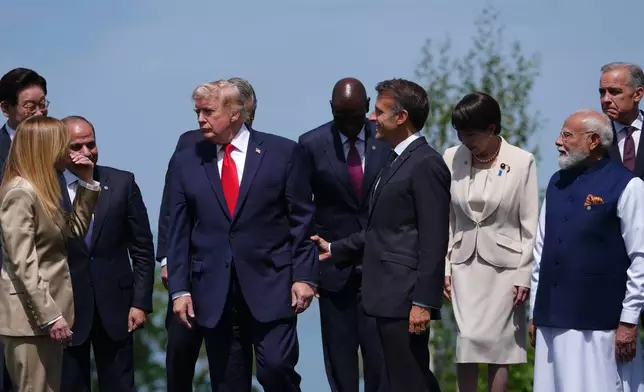 From left, South Korea's President Lee Jae Myung, Italian Prime Minister Giorgia Meloni, Egyptian President Abdel-Fattah el Sissi, U.S. President Donald Trump, Kenya's President William Ruto, French President Emmanuel Macron Japan's Prime Minister Sanae Takaichi, India's Prime Minister Narenda Modi and Canadian Prime Minister Mark Carney during a group photo of G7 leaders and invited nations during the G7 summit in Evian-les-Bains, France, Tuesday, June 16, 2026. (AP Photo/Thibault Camus)
