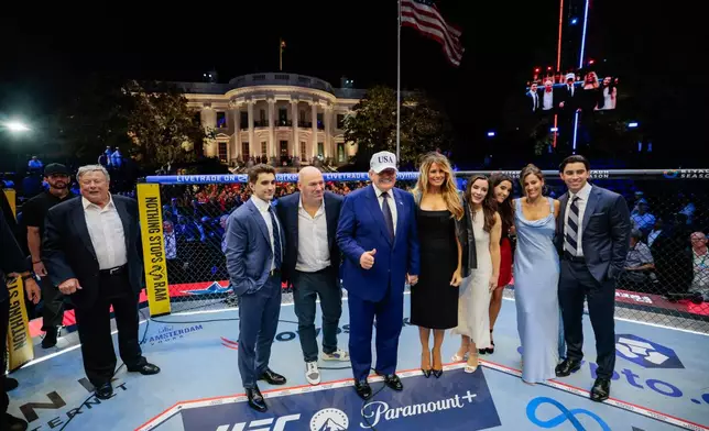 President Donald Trump, first lady Melania Trump, UFC President and CEO Dana White and other guests pose inside the octagon after UFC Freedom 250 on the South Lawn of the White House, Monday, June 15, 2026, in Washington. (Evan Vucci/Pool Photo via AP)