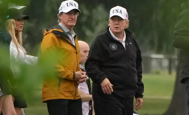 President Donald Trump, from right, and Interior Secretary Doug Burgum tour the East Potomac Park golf course, Sunday, June 28, 2026, in Washington. (AP Photo/Mark Schiefelbein)
