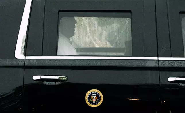 President Donald Trump rides in his limousine as he leaves Trump National Golf Club in Sterling, Va, Sunday, June 28, 2026. (AP Photo/Mark Schiefelbein)