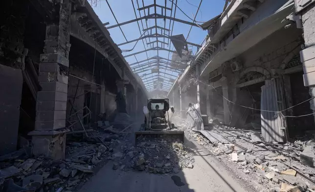 A municipality worker uses a skid loader as he cleans a destroyed market shop following the announcement of an initial ceasefire agreement between the United States and Iran, in Nabatiyeh town, southern Lebanon, Tuesday, June 16, 2026. (AP Photo/Hussein Malla)