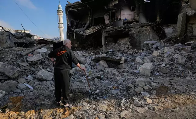 Kamal al-Kamal, 75, who returned to his village following the announcement of an initial ceasefire agreement between the United States and Iran, checks his destroyed supermarket in Nabatiyeh town, southern Lebanon, Tuesday, June 16, 2026. (AP Photo/Hussein Malla)