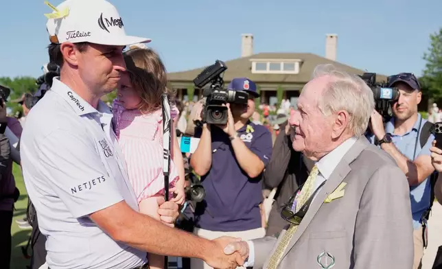 J.T. Poston shakes hands with Jack Nicklaus after winning the Memorial golf tournament, Sunday, June 7, 2026, in Dublin, Ohio. (AP Photo/Sue Ogrocki)