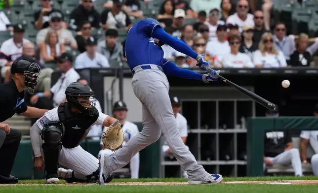 Los Angeles Dodgers' Freddie Freeman hits a solo home run during the first inning of a baseball game against the Chicago White Sox in Chicago, Sunday, June 14, 2026. (AP Photo/Nam Y. Huh)