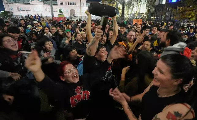People gather to remember Carlos Alberto Solari, the Argentine singer-songwriter known as "the Indio" who led Patricio Rey y sus Redonditos de Ricota, on the day of his death, at Plaza de Mayo square in Buenos Aires, Argentina, Friday, June 5, 2026. (AP Photo/Gustavo Garello)