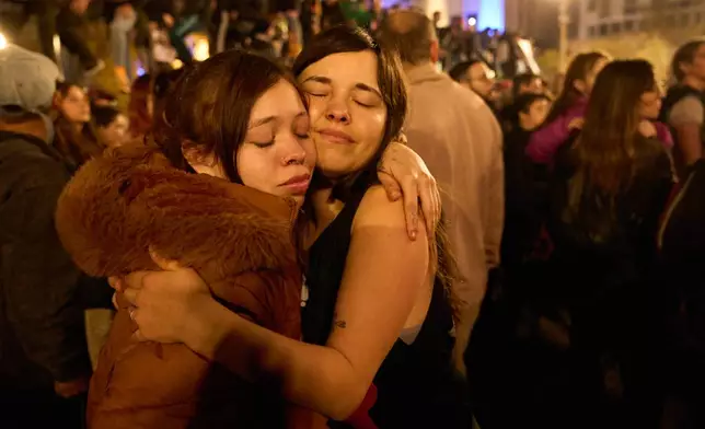 People gather to remember Carlos Alberto Solari, the Argentine singer-songwriter known as "the Indio" who led Patricio Rey y sus Redonditos de Ricota, on the day of his death, at Plaza de Mayo square in Buenos Aires, Argentina, Friday, June 5, 2026. (AP Photo/Victor R. Caivano)