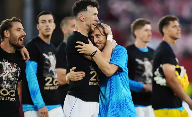 Croatia's Luka Modric, center right, celebrates with Ivan Perisic after defeating Panama as teammates wear shirts honouring his 200th appearance for Croatia following a World Cup Group L soccer match, in Toronto, on Tuesday, June 23, 2026. (Nathan Denette/The Canadian Press via AP)
