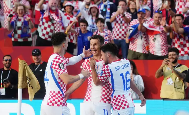 Croatia's Ante Budimir (centre) celebrates his goal against Panama with Ivan Perisic (14) and Martin Baturina (16) during the second half of a World Cup Group L soccer match, in Toronto, on Tuesday, June 23, 2026. (Nathan Denette/The Canadian Press via AP)