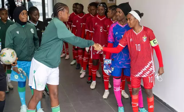 Sudan's U-17 women's national team, left, shakes hand with Comorros women's national team, ahead of their soccer match during qualifiers for the 2028 Los Angeles Summer Olympics, in Casablanca, Morocco, Monday, June 8, 2026. (AP Photo)