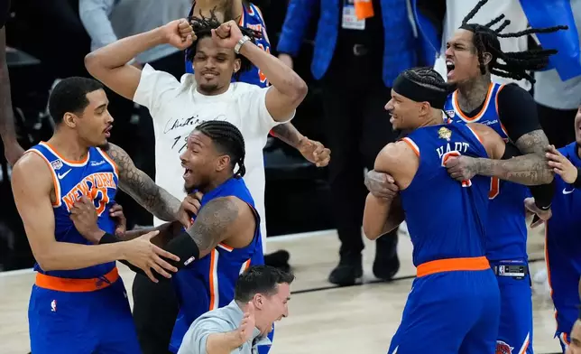 The New York Knicks celebrate after defeating the San Antonio Spurs in Game 5 of the NBA Finals basketball series, Saturday, June 13, 2026, in San Antonio. (AP Photo/Ross D. Franklin)