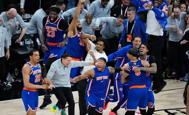The New York Knicks celebrate after defeating the San Antonio Spurs in Game 5 of the NBA Finals basketball series, Saturday, June 13, 2026, in San Antonio. (AP Photo/Ross D. Franklin)