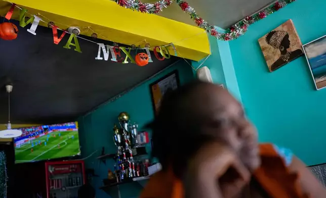 Vivianne Petit Frere looks on below a "viva Mexico" sign at her Haitian food restaurant, Lakou Lakay, June 17, 2026, in Tijuana, Mexico. (AP Photo/Gregory Bull)
