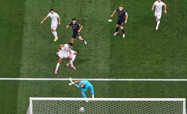 New Zealand's Elijah Just (11), center, scores their opening goal during the World Cup Group G soccer match between Iran and New Zealand in Inglewood, Calif., near Los Angeles, Monday, June 15, 2026. (AP Photo/Mark J. Terrill)