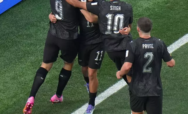 New Zealand's Elijah Just, center, celebrates with Chris Wood (9) and Sarpreet Singh (10) and Tim Payne (2) after scoring their opening goal during the World Cup Group G soccer match between Iran and New Zealand in Inglewood, Calif., near Los Angeles, Monday, June 15, 2026. (AP Photo/Jae C. Hong)