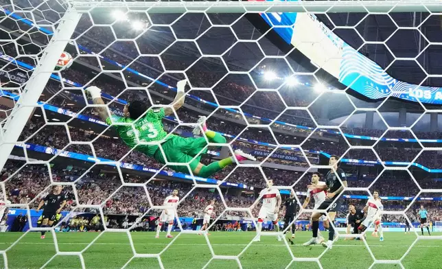 Tunisia's Moutaz Neffati (23) makes a diving save on a shot by United States' Christian Pulisic (10) during the World Cup Group D soccer match between Turkey and the United States in Inglewood, Calif., near Los Angeles, Thursday, June 25, 2026. (AP Photo/Andre Penner)