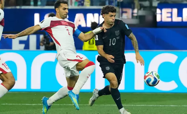 United States' Christian Pulisic (10) and Turkey's Zeki Celik battle for the ball during the World Cup Group D soccer match in Inglewood, Calif., near Los Angeles, Thursday, June 25, 2026. (AP Photo/Andre Penner)