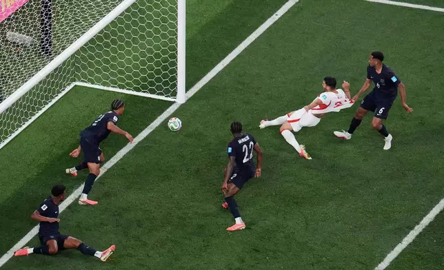 Turkey's Kaan Ayhan, second from right, scores their third goal as United States' Auston Trusty (6) defends and United States' Mark McKenzie (22) and United States' Miles Robinson (12) look on during the second half of a World Cup Group D soccer match in Inglewood, Calif., near Los Angeles, Thursday, June 25, 2026. (AP Photo/Marcio J. Sanchez)
