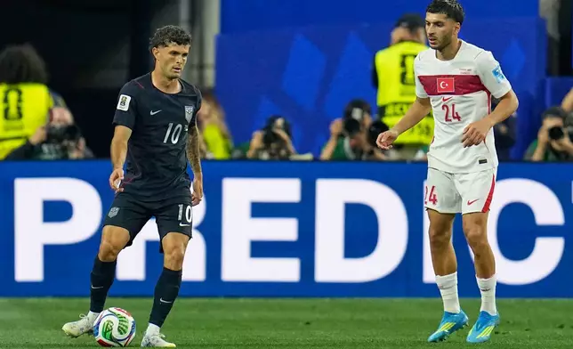 United States' Christian Pulisic (10) and Turkey's Oguz Aydin (24) compete for the ball during the World Cup Group D soccer match between Turkey and the United States in Inglewood, Calif., near Los Angeles, Thursday, June 25, 2026. (AP Photo/Gregory Bull)