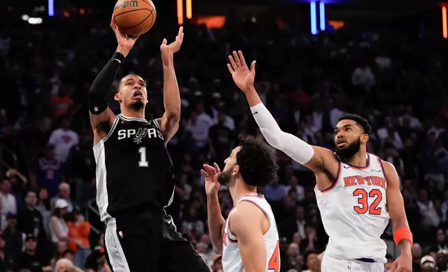 San Antonio Spurs forward Victor Wembanyama (1) shoots over New York Knicks center Karl-Anthony Towns (32) during second half of Game 3 of the NBA Finals basketball series, Monday, June 8, 2026, in New York. (AP Photo/Ross D. Franklin)