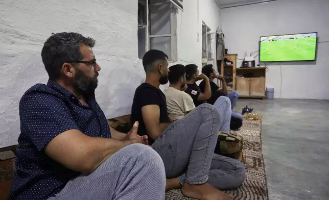 A small group of Yazidis gather to watch the Germany-Ecuador match at the home of community leader Ismail Dalaf in Khirbet al-Ghazal, northeastern Syria, late Thursday, June 25, 2026.(AP Photo/Hogir Al Abdo)
