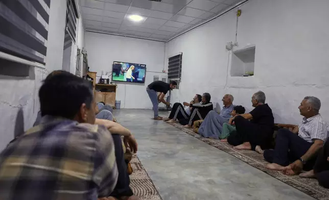 A small group of Yazidis gather to watch the Germany-Ecuador match at the home of community leader Ismail Dalaf in Khirbet al-Ghazal, northeastern Syria, late Thursday, June 25, 2026.(AP Photo/Hogir Al Abdo)
