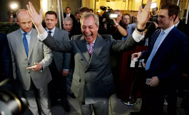 FILE - Nigel Farage, the leader of the UK Independence Party, celebrates and poses for photographers as he leaves a "Leave.EU" organization party for the British European Union membership referendum in London., June 24, 2016. (AP Photo/Matt Dunham, File)