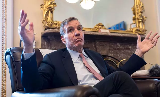 Sen. Mark Warner, D-Va., the vice chair of the Senate Intelligence Committee, speaks to reporters about FISA, the law that allows the U.S. to gather intelligence abroad, at the Capitol in Washington, Thursday, June 11, 2026. (AP Photo/J. Scott Applewhite)