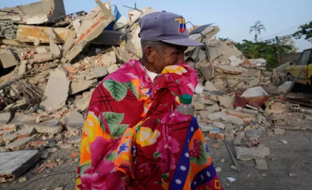 A man stands in front of a collapsed building two days after an earthquake struck La Guaira, Venezuela, Friday, June 26, 2026.(AP Photo/Ariana Cubillos)