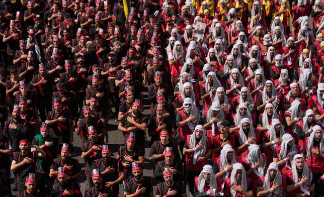 Hezbollah supporters beat their chests, as they march during the holy day of Ashoura that commemorates the 7th century martyrdom of the Prophet Muhammad's grandson Hussein, in Dahiyeh, Beirut's southern suburbs, Lebanon, Friday, June 26, 2026. (AP Photo/Hussein Malla)